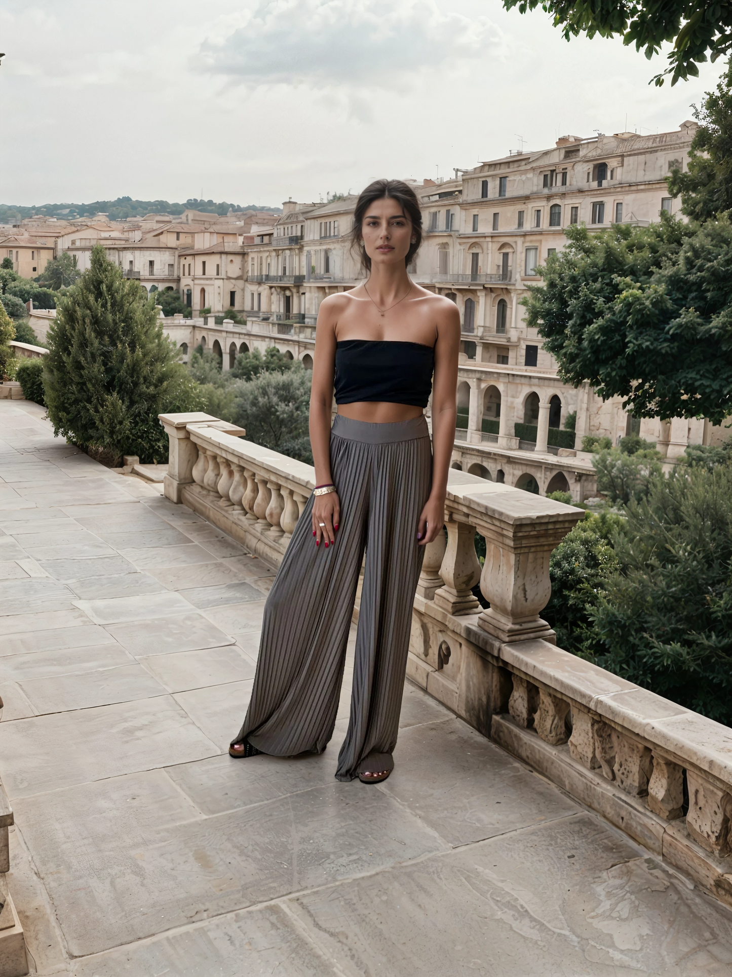 Model wearing high-waisted pleated palazzo pants with a bandeau top in a boutique setting.